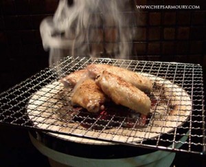Chicken wings cooking on the shichirin